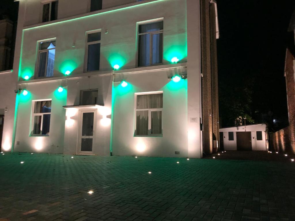 a building with green lights on the side of it at Victorin House - All rooms are EN-SUITE in Portsmouth