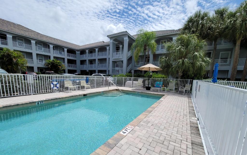 a swimming pool in front of a large building at Our Naples Hideaway in Naples