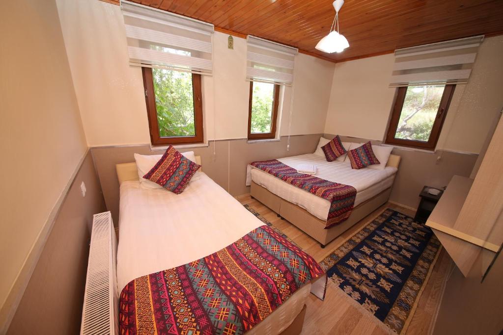 Postel nebo postele na pokoji v ubytování Emiroğlu Konak Otel