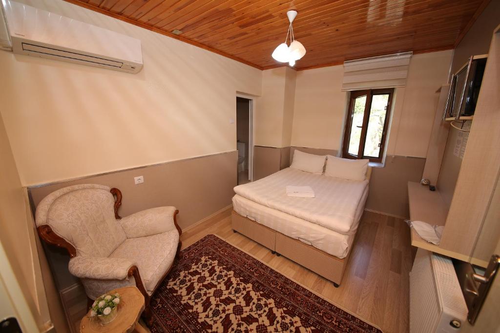Postel nebo postele na pokoji v ubytování Emiroğlu Konak Otel