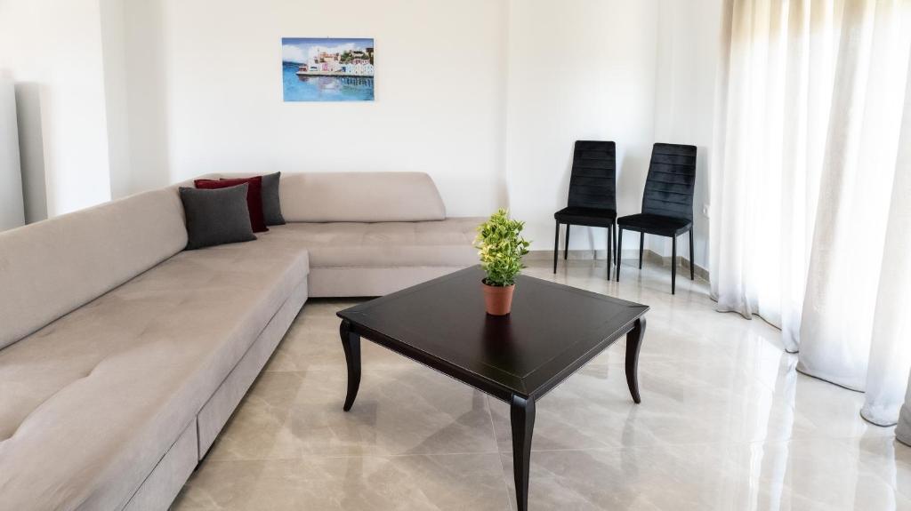 a living room with a couch and a table at Mythic Villas in Epanomi