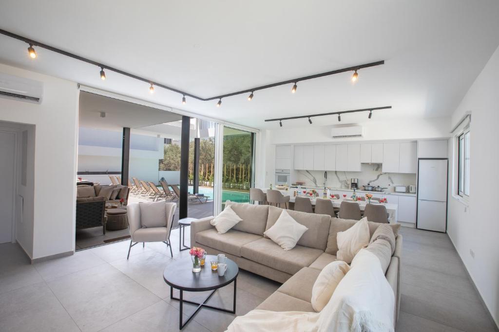 a living room with a couch and a table at Kube Luxury Villas in Ayia Napa