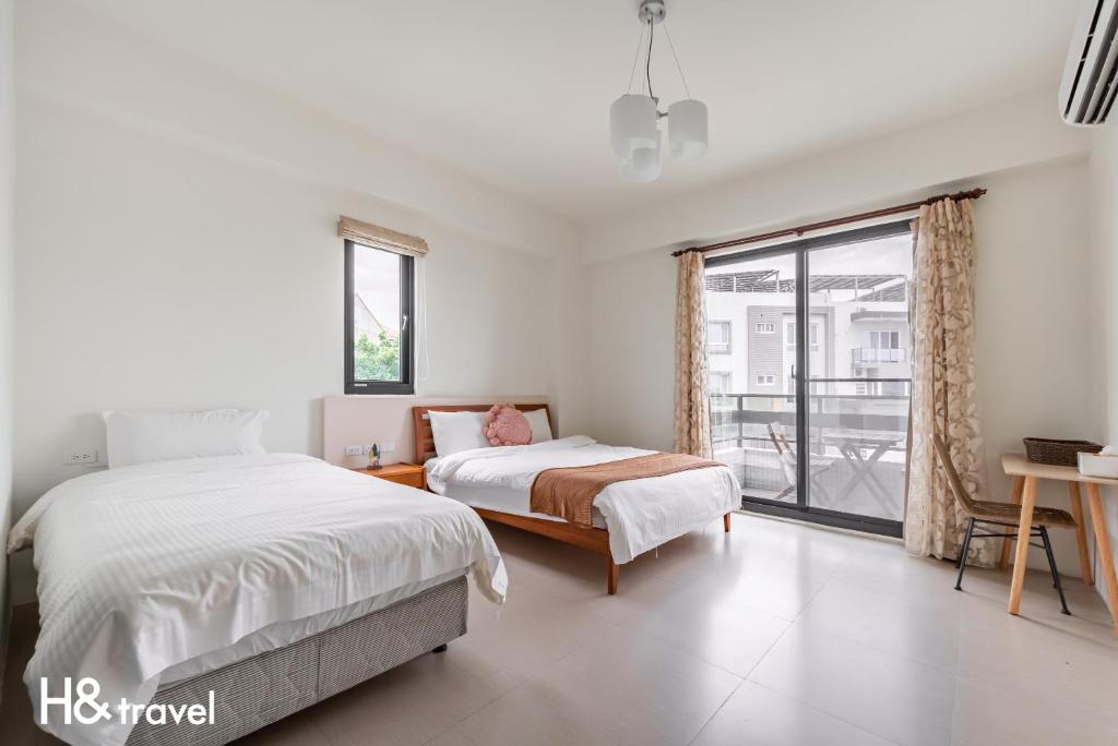 Postel nebo postele na pokoji v ubytování Taitung Rainbow Pet Friendly Maison Resort