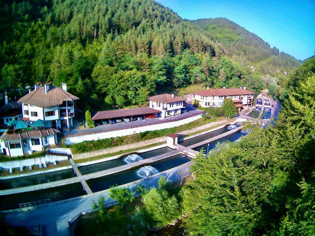 an aerial view of a village with a river and houses at Fisherman's Hut Family Hotel in Beden