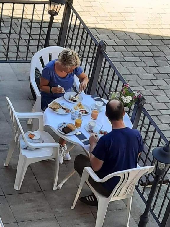 a man and woman sitting at a table eating food at Hotel Luca in Betzenstein