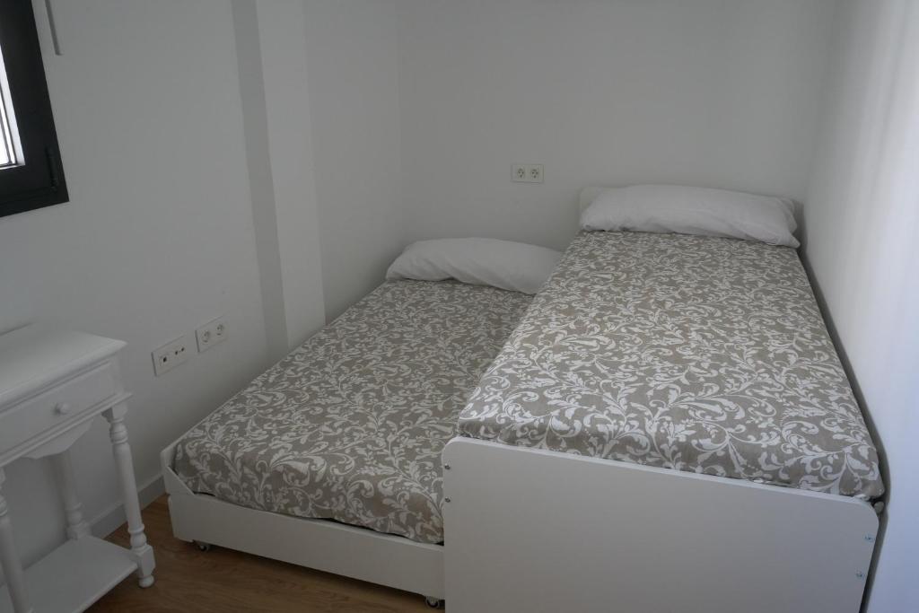 Posteľ alebo postele v izbe v ubytovaní Almona de Triana - Kainga Homes