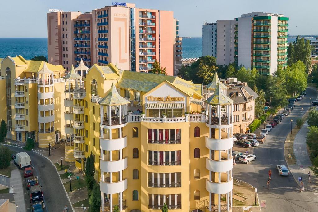 an aerial view of a yellow building in a city at Apartments in Victoria Residence in Sunny Beach