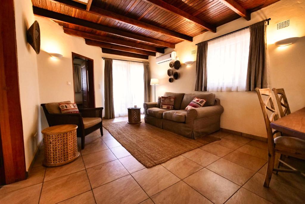 a living room with a couch and a table at Leopards Hill Lodge in Lusaka