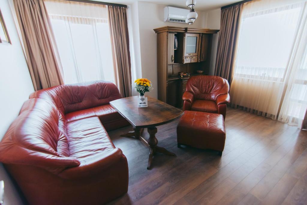 a living room with a couch and a table and chairs at RELAX Apartments in HASKOVO, Apt1 in Haskovo