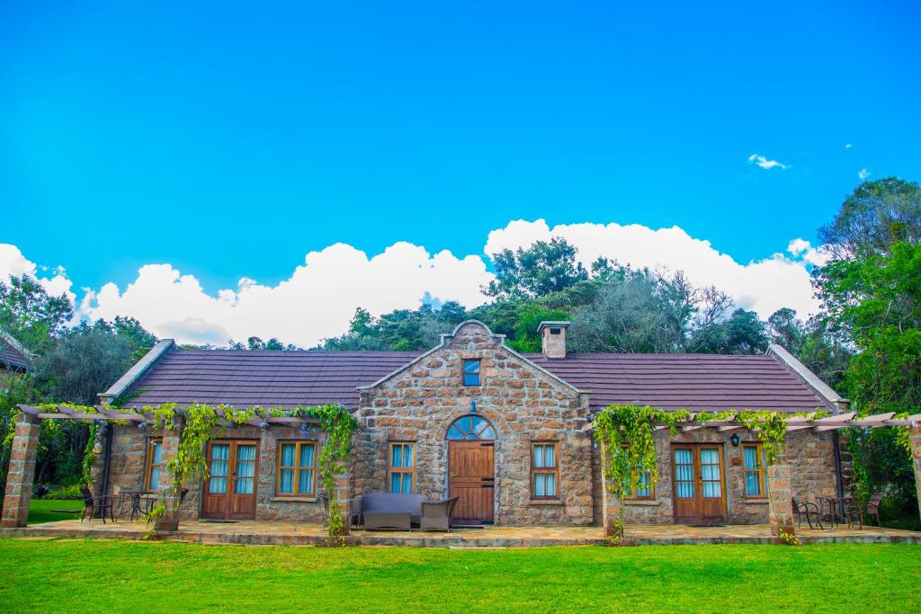 a stone house with a yard at The Residences at Karen in Nairobi