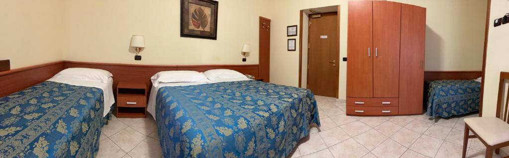 Postel nebo postele na pokoji v ubytování Hotel Dei Pini