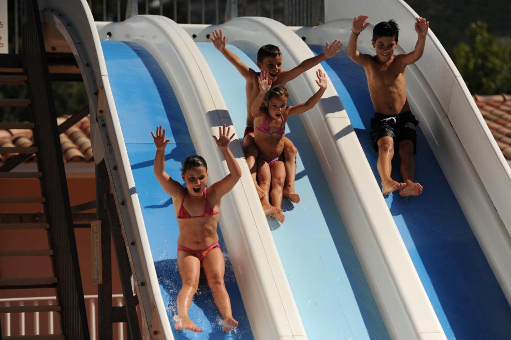 a group of children jumping on a water slide at Résidence Les Castors in Calvi