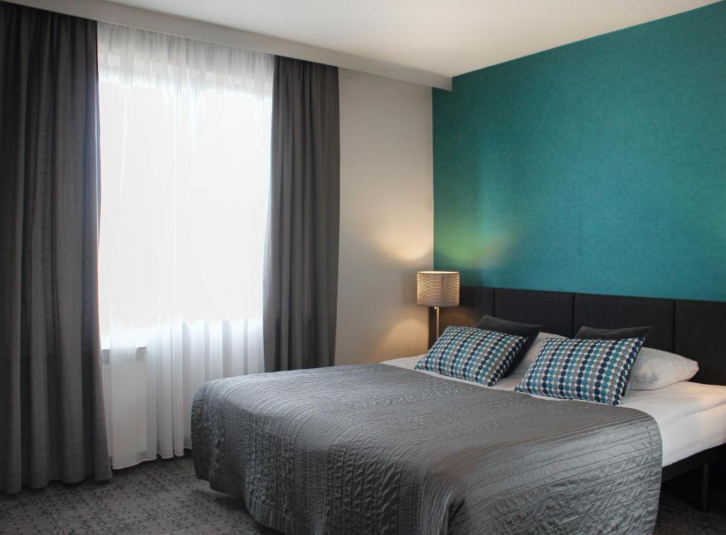 Posteľ alebo postele v izbe v ubytovaní Hotel Perła