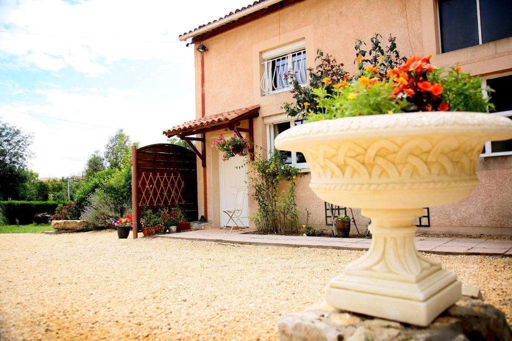 a large flower pot sitting on a rock in front of a house at Launie Lea in Eyzerac