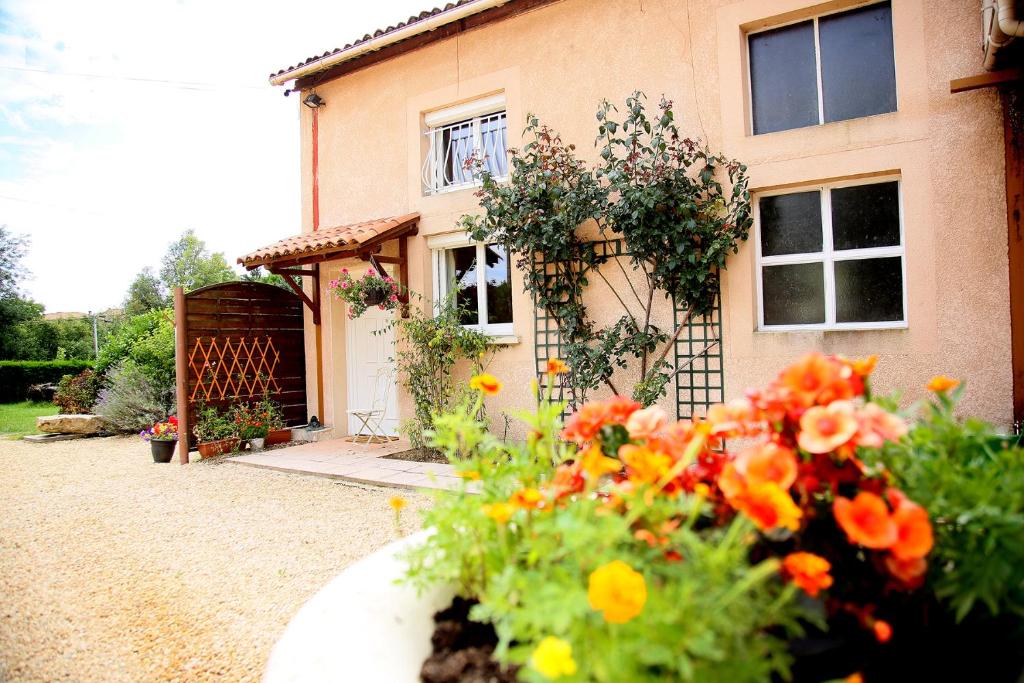 a house with a bunch of flowers in front of it at Launie Lea in Eyzerac