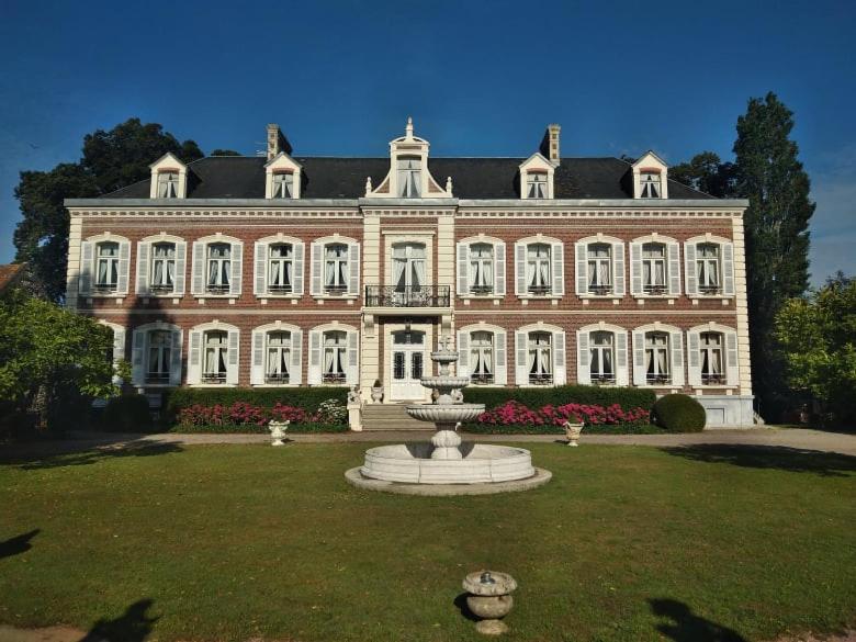 a large building with a fountain in front of it at Château "Le Castel des Anges" in Wailly-Beaucamp