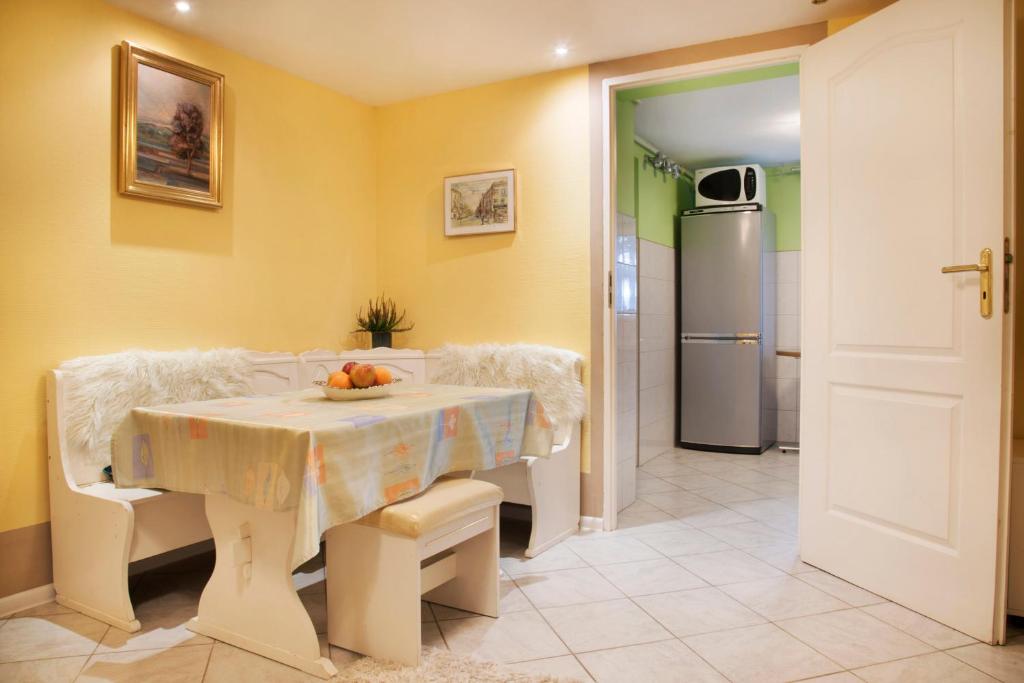 a kitchen with a table and a refrigerator at Górska Kraina in Bielsko-Biala