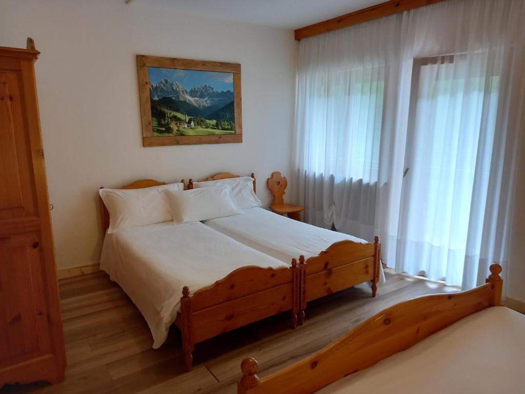 Postel nebo postele na pokoji v ubytování Albergo Scoiattolo