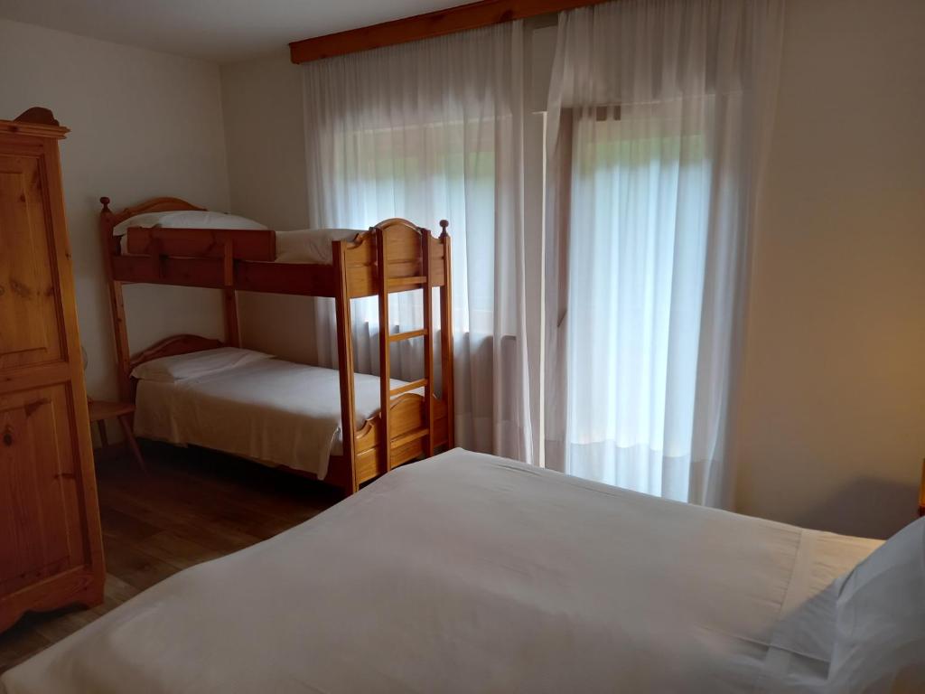 Postel nebo postele na pokoji v ubytování Albergo Scoiattolo