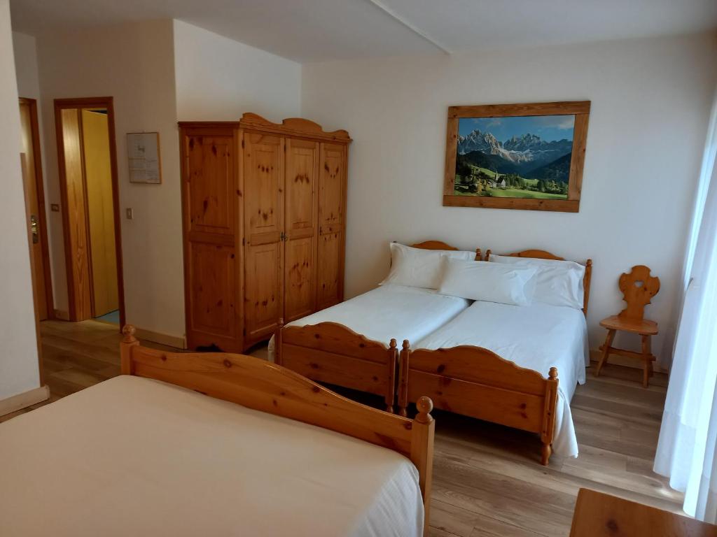 Postel nebo postele na pokoji v ubytování Albergo Scoiattolo