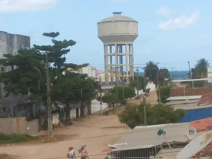 a water tower in the middle of a city at Temporada Carnaval Praia Olinda e Recife in Paulista