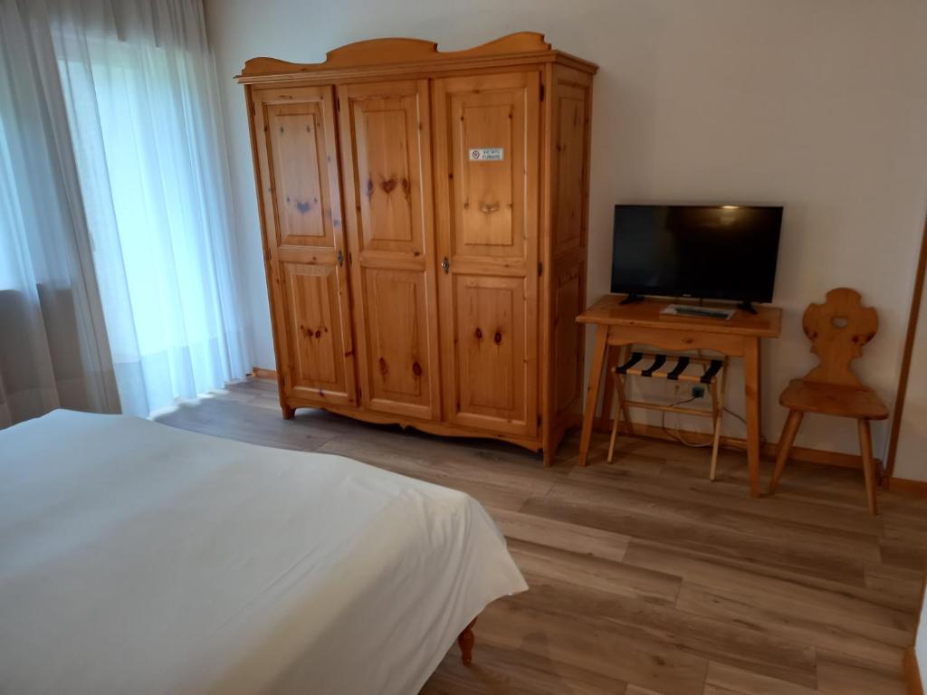 Postel nebo postele na pokoji v ubytování Albergo Scoiattolo