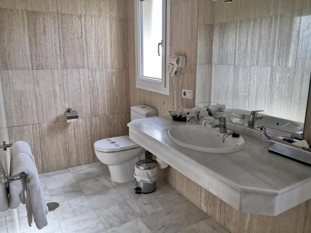 a bathroom with a sink and a toilet at La Luna Blanca in Torremolinos