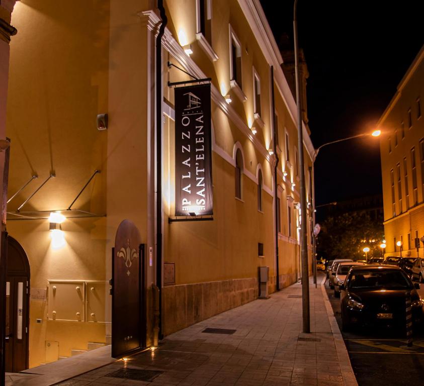 a sign on the side of a building at night at Palazzo Sant'Elena in Foggia