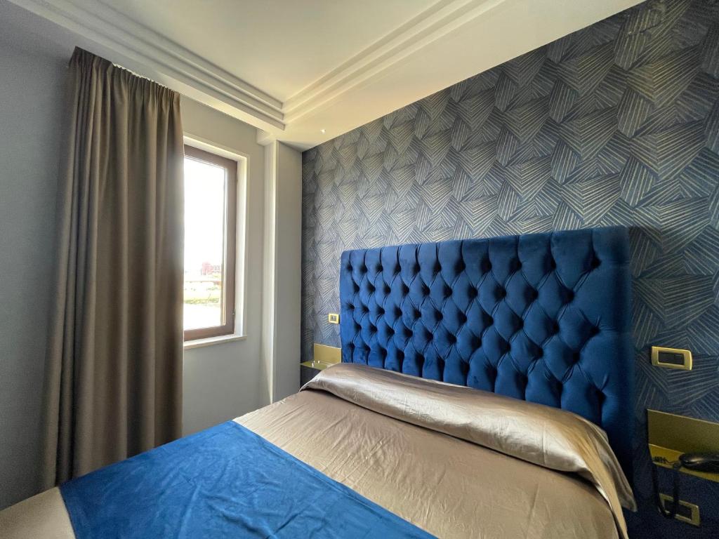 Postel nebo postele na pokoji v ubytování Ninfa hotel