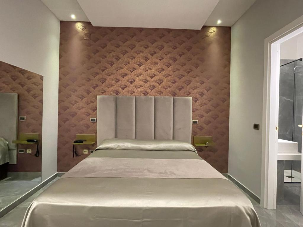 Postel nebo postele na pokoji v ubytování Ninfa hotel