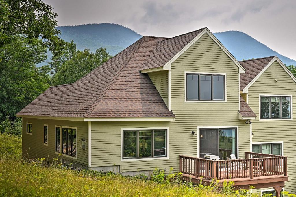 a large house with a deck on a hill at Slopeside Jackson Townhome on Black Mountain in Jackson