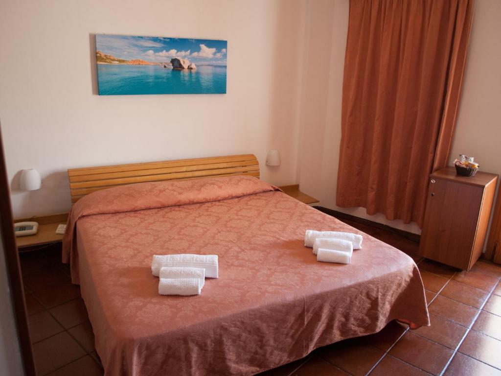 Postel nebo postele na pokoji v ubytování Hotel Garibaldi