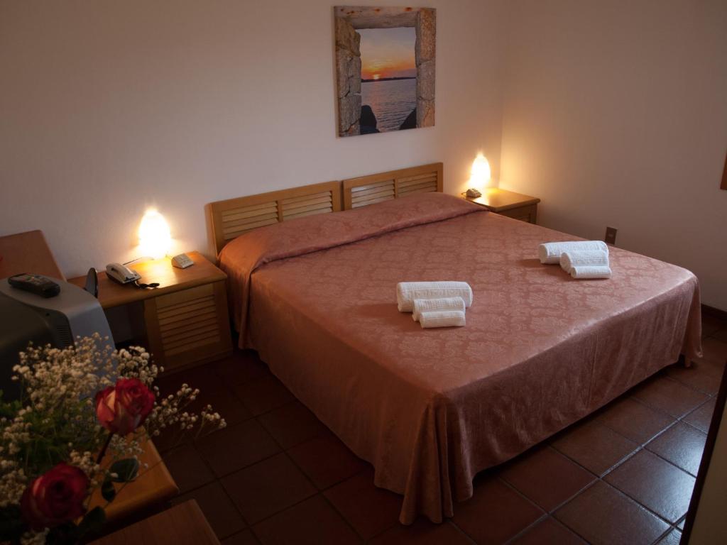 Postel nebo postele na pokoji v ubytování Hotel Garibaldi