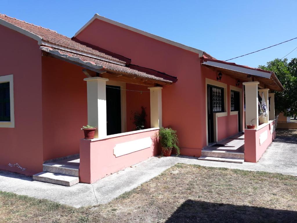 a house with a red house at Aggeliki Apartments in Sidari