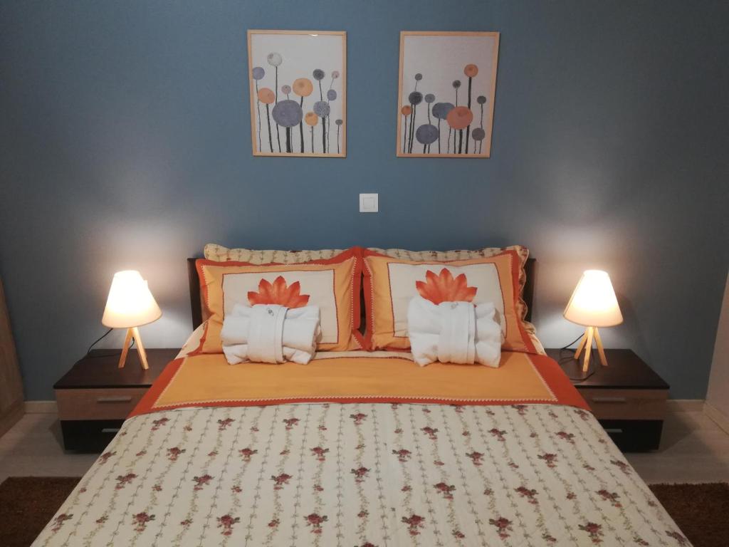 a bedroom with a bed with two lamps at Central Apartment in Thessaloniki