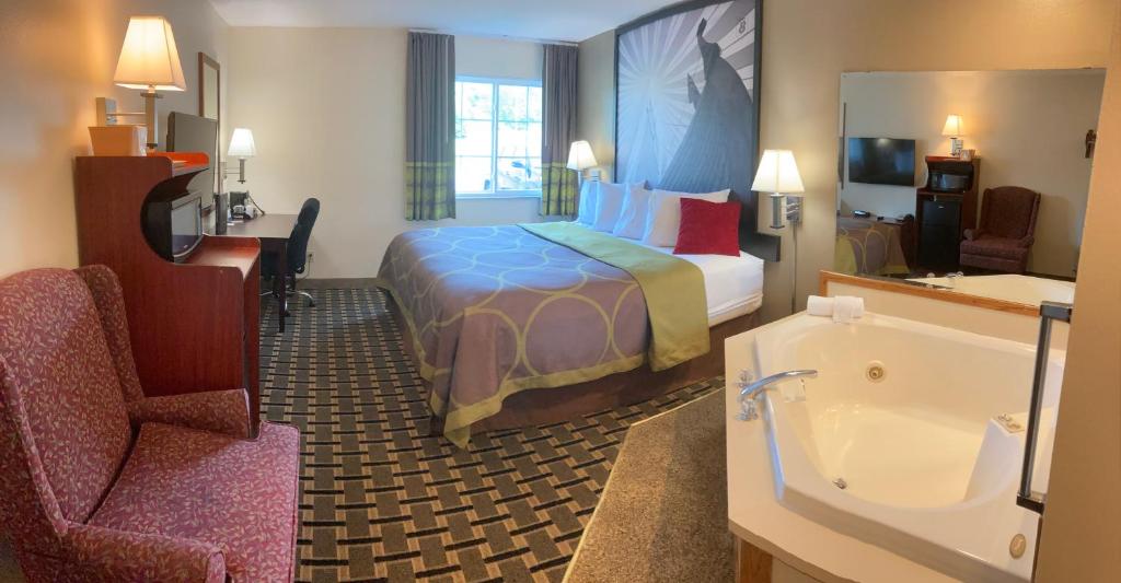 a hotel room with a bed and a bathroom at Super 8 by Wyndham Chisago City in Chisago City