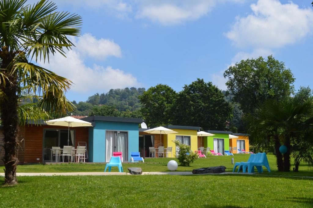 a row of colourful houses in a yard at Albaluce Village Viverone in Viverone