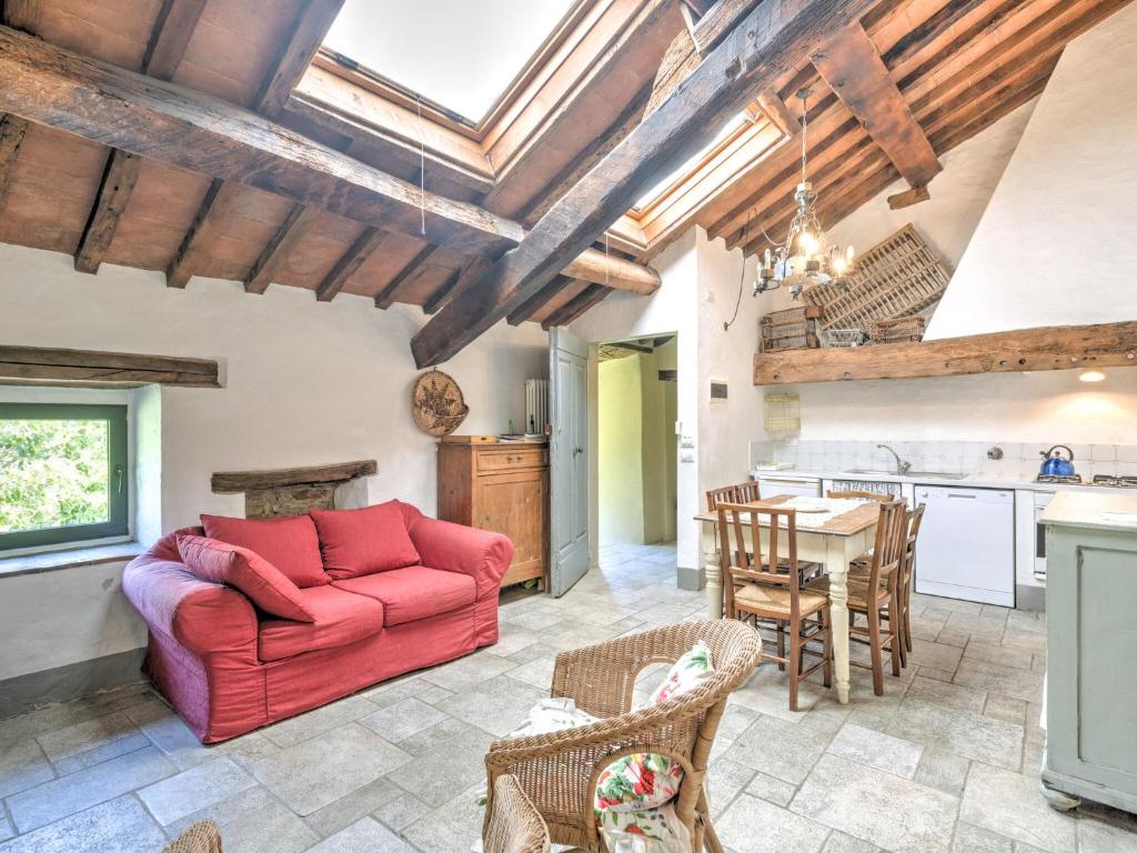 a living room with a red couch and a table at Belvilla by Oyo San Godenzo Casa Grande 2 in San Godenzo
