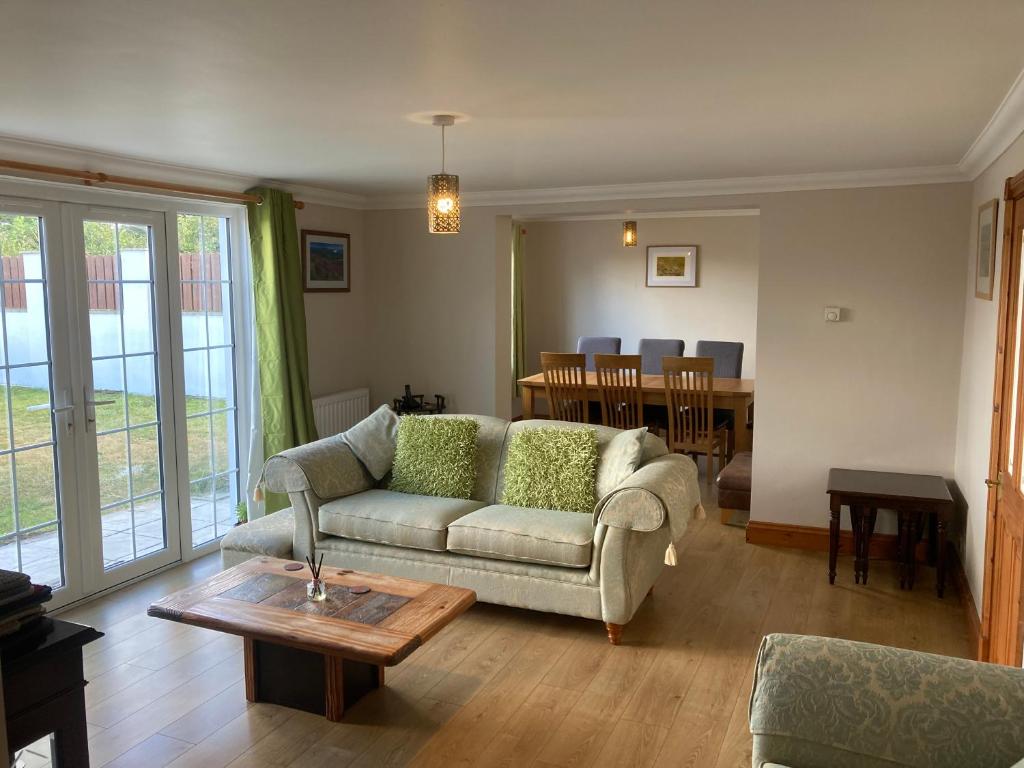 a living room with a couch and a table at Bader House in Aberporth