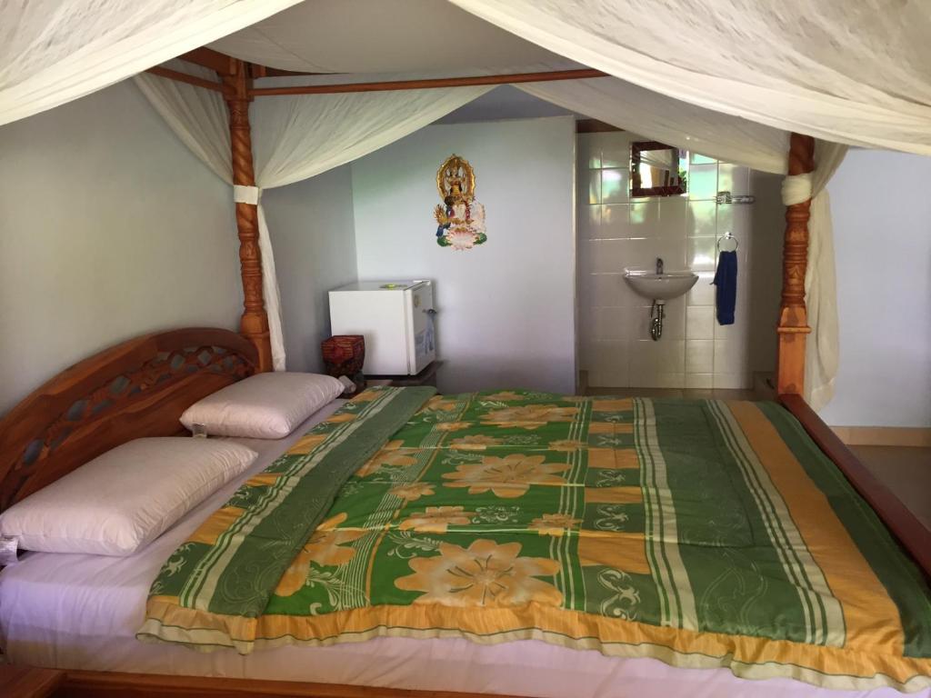 Postel nebo postele na pokoji v ubytování Bali Cottage Sambirenteng