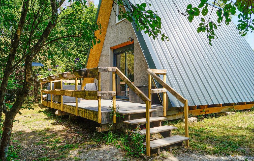 a wooden staircase leading to a house with a porch at Awesome Home In Bibiche With Kitchenette 