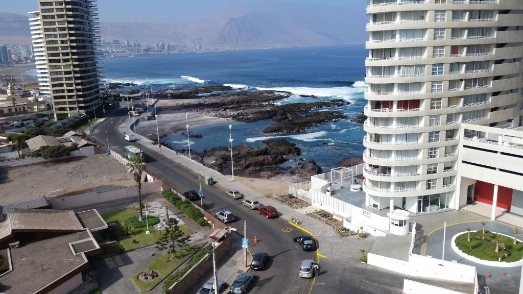 an aerial view of a city with the ocean and buildings at Departamentos Nautilus in Iquique
