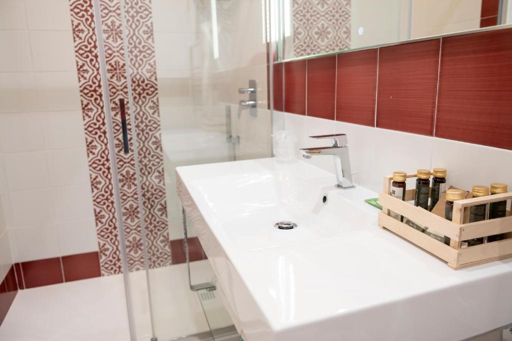 a bathroom with a white sink and a shower at Casa Marino in Sorrento