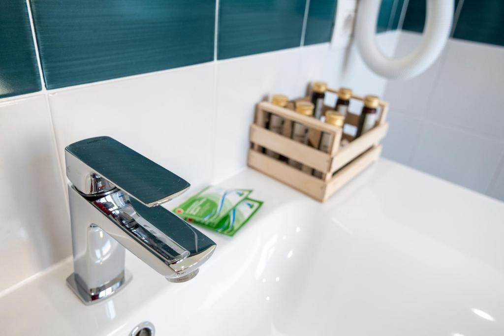 a bathroom sink with a soap dispenser on it at Casa Marino in Sorrento