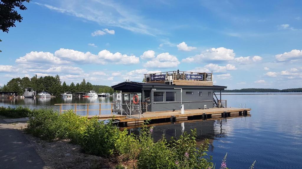 a house on a dock on a large body of water at Saunalautta Sisu in Imatra