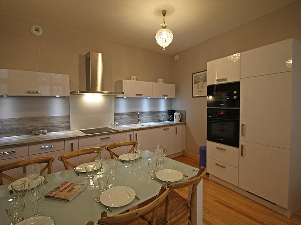 a kitchen with a table with wine glasses on it at Gîte Épinal, 4 pièces, 6 personnes - FR-1-589-82 in Épinal
