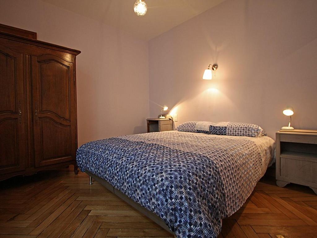 a bedroom with a bed and a cabinet and lights at Gîte Épinal, 4 pièces, 6 personnes - FR-1-589-82 in Épinal