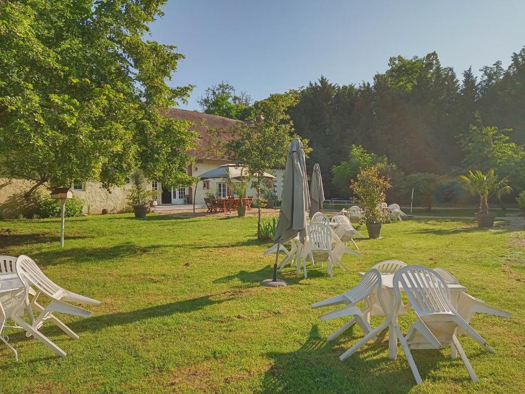 a group of lawn chairs and an umbrella at Le Domaine de JAUGY in Gièvres