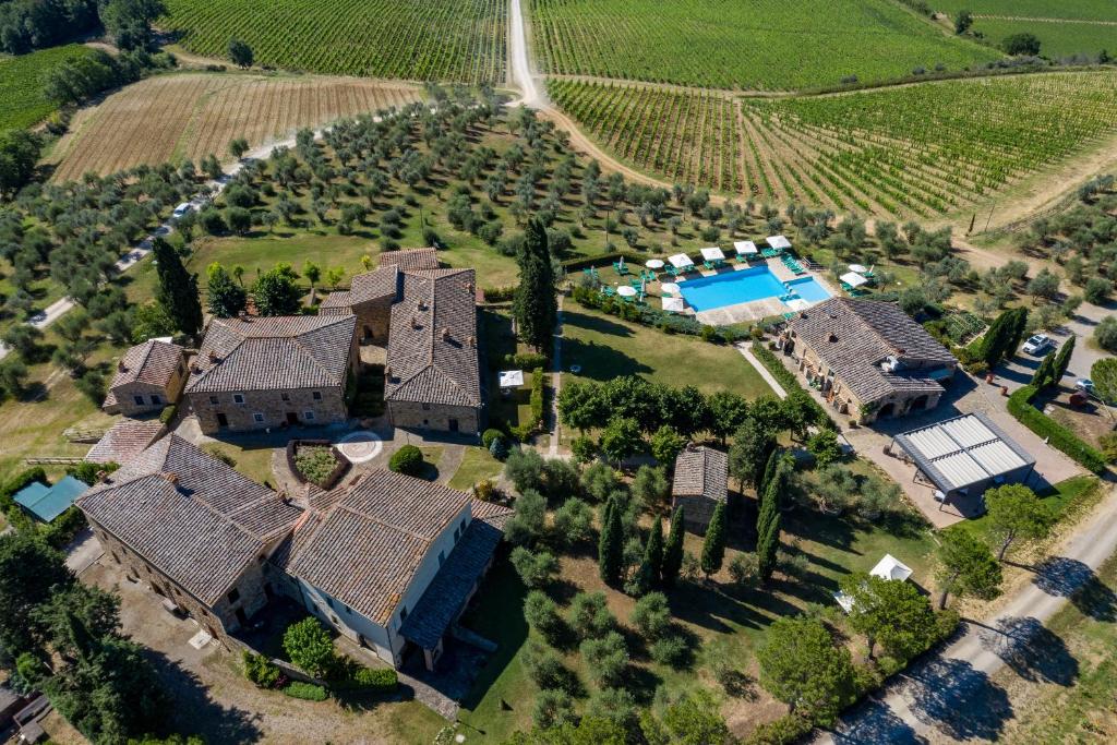 an aerial view of a house with a swimming pool at Relais Riserva di Fizzano in Castellina in Chianti