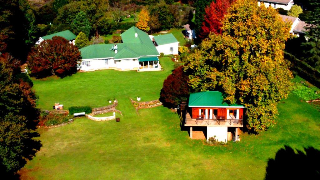 an aerial view of a house on a green field at Sani Window B&B and Self catering in Underberg